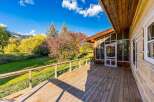 Enjoy the stunning natural beauty from this expansive wooden deck, perfect for outdoor living and entertaining.