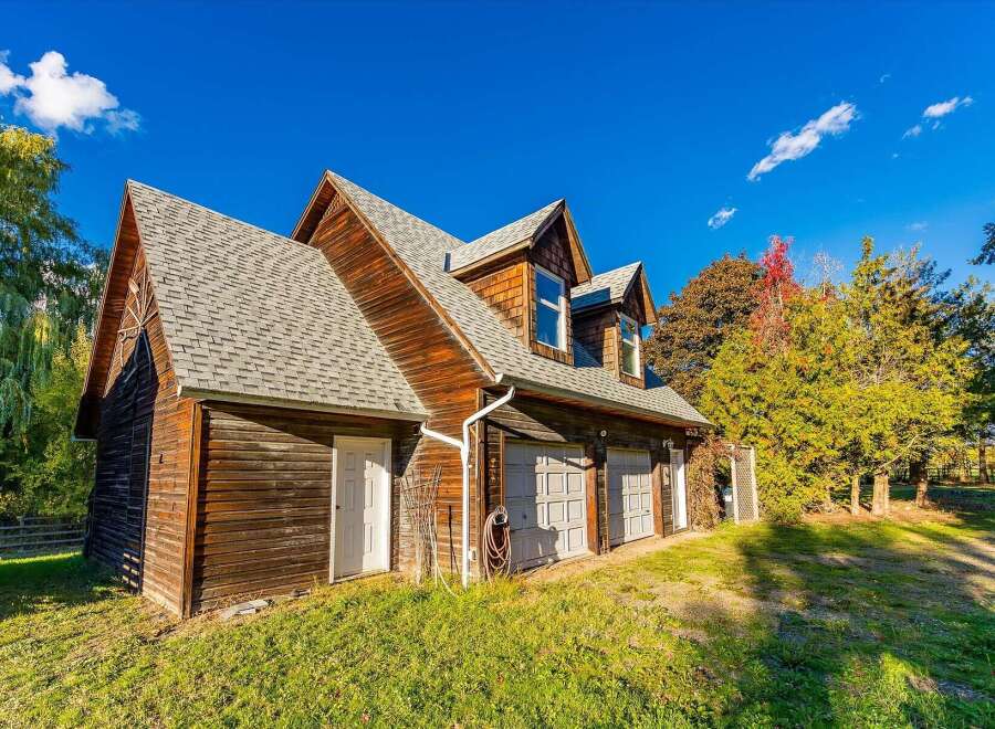 This charming wooden structure features a multi-level roof with dormer windows, offering ample natural light and character.