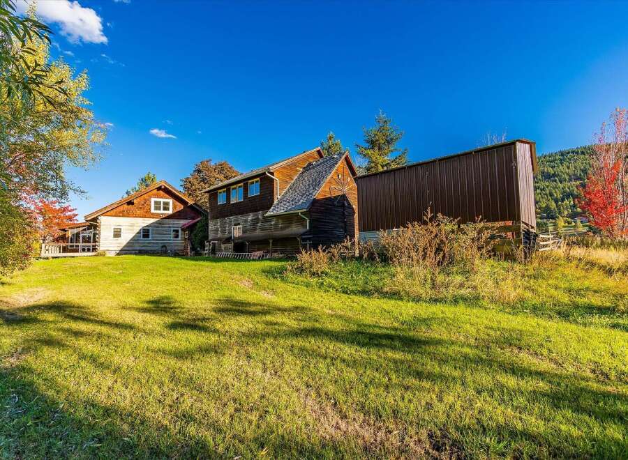 Discover this charming property featuring rustic log cabin architecture and a spacious screened-in porch, perfect for enjoying the serene surroundings.