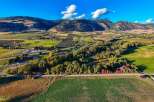 Experience the beauty of autumn in this stunning aerial view of a rural landscape.