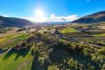 Experience breathtaking panoramic views of rolling hills and lush green fields from this stunning aerial perspective.
