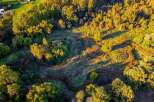 Experience the beauty of nature with this stunning aerial view of a property bathed in golden hour light.