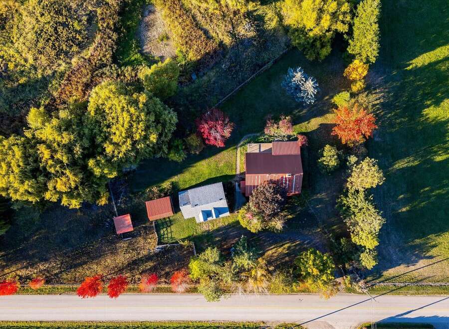 Experience the charm of rural living with this picturesque property, bathed in the warm glow of autumn sunlight.