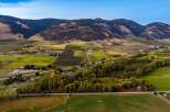 Experience the beauty of this expansive rural landscape, featuring rolling hills, lush green fields, and meticulously maintained vineyards.