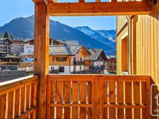 Experience breathtaking mountain views from this charming wooden balcony, perfect for enjoying your morning coffee or evening relaxation.
