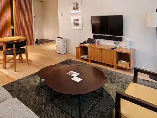 Experience modern living in this beautifully appointed apartment, featuring a spacious living area with a comfortable sofa and a sleek entertainment center.