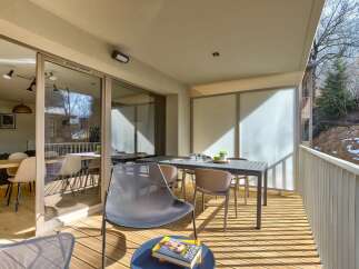 Enjoy your morning coffee on this spacious balcony, complete with a dining table and chairs perfect for al fresco meals.