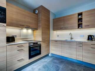 Experience modern living in this beautifully designed kitchen, featuring sleek light wood cabinetry and integrated appliances.