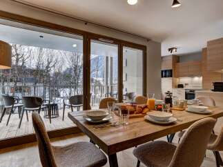 Enjoy a delightful breakfast spread in this modern dining area, complete with a rustic wooden table set for a meal.