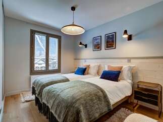 This charming bedroom features two comfortable twin beds, perfect for accommodating guests or family.