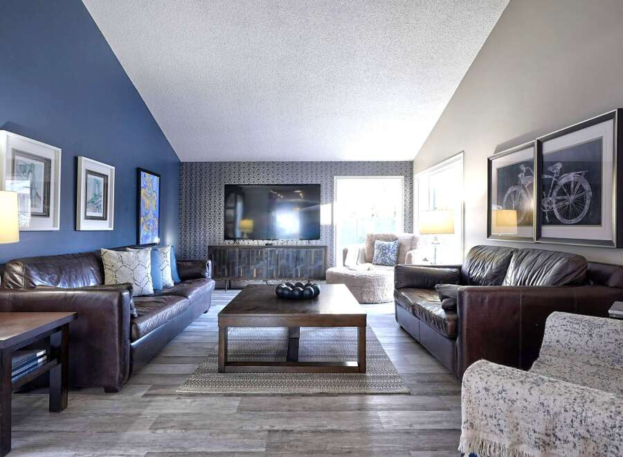 Experience luxurious living in this stunning living room, featuring rich brown leather sofas perfect for relaxation and entertaining.