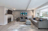 Step into this inviting living room, featuring a modern fireplace and a large flat-screen TV mounted above.