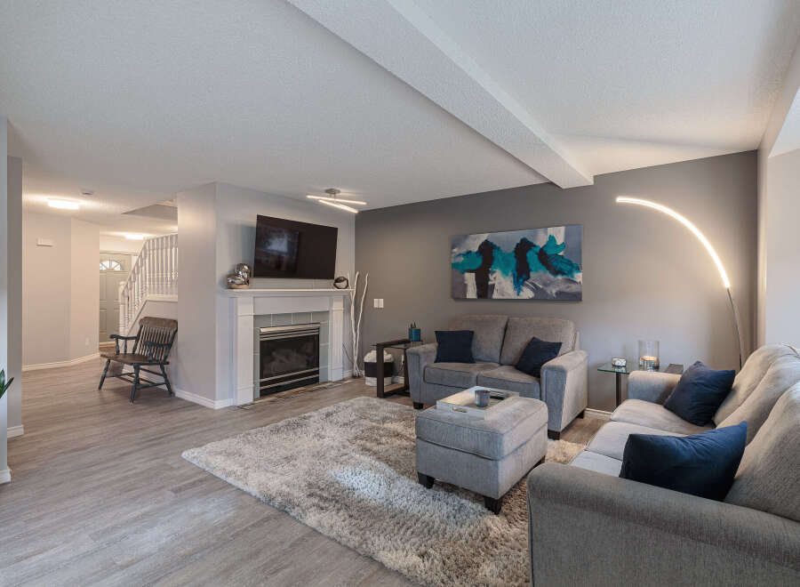 Step into this inviting living room, featuring a modern fireplace and a large flat-screen TV.
