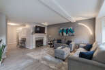 Step into this inviting living room, featuring a modern fireplace and a large flat-screen TV.