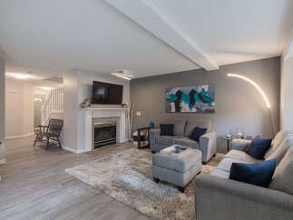 Step into this inviting living room, featuring a modern fireplace and a large flat-screen TV.