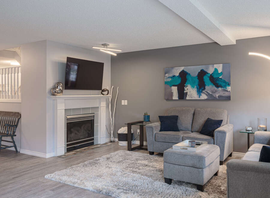 Step into this inviting living room, featuring a modern fireplace and a large flat-screen TV, perfect for cozy evenings.