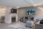 Step into this inviting living room, featuring a modern fireplace and a large flat-screen TV, perfect for cozy evenings.