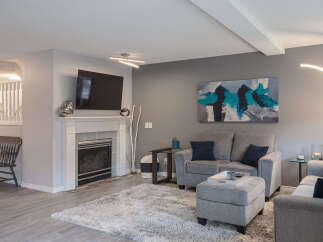 Step into this inviting living room, featuring a modern fireplace and a large flat-screen TV, perfect for cozy evenings.