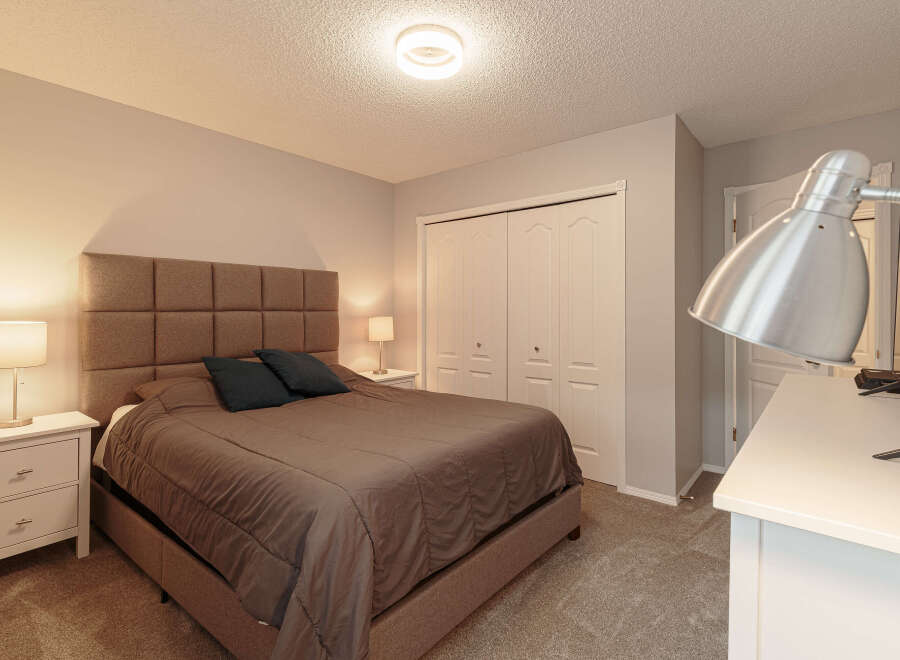 Step into this inviting bedroom, featuring a plush, upholstered headboard that adds a touch of elegance.
