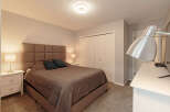 Step into this inviting bedroom, featuring a plush, upholstered headboard that adds a touch of elegance.