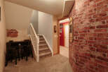 This inviting space features a cozy bar area with dark wood stools, perfect for entertaining.