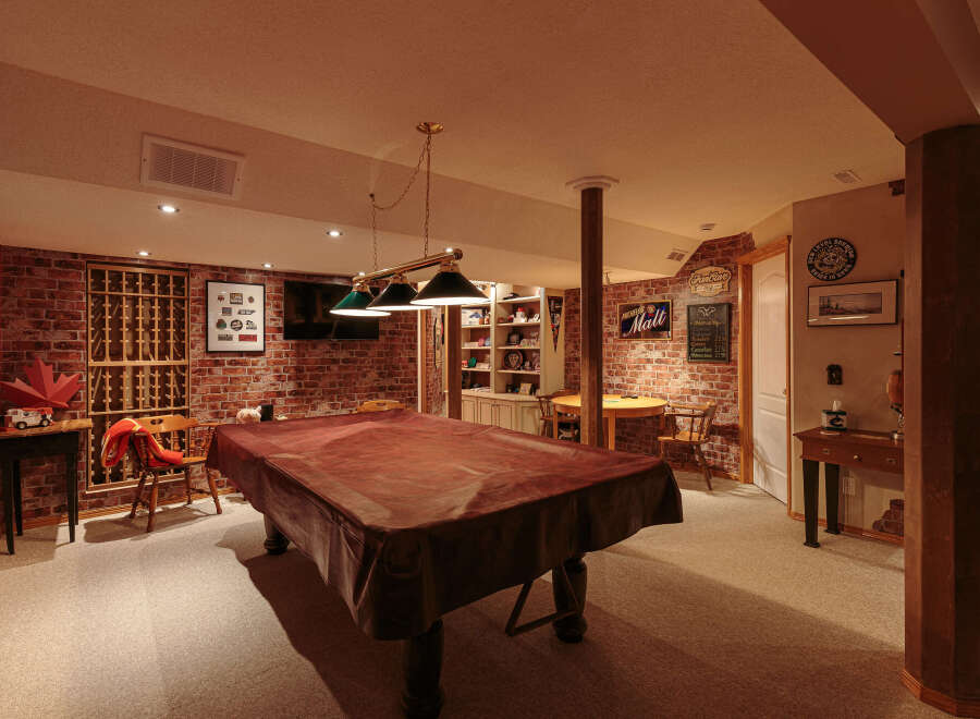 Step into this inviting basement recreation room, perfect for entertaining guests or enjoying a night in.