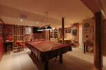 Step into this inviting basement recreation room, perfect for entertaining guests or enjoying a night in.