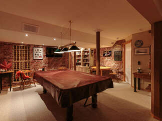 Step into this inviting basement recreation room, perfect for entertaining guests or enjoying a night in.