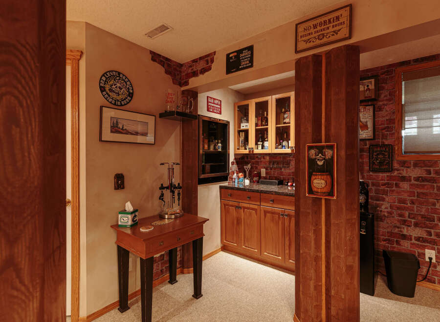 Step into this charming basement bar area, perfect for entertaining guests.