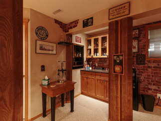 Step into this charming basement bar area, perfect for entertaining guests.