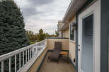 Enjoy your morning coffee or evening relaxation on this private balcony, complete with a comfortable chaise lounge and a convenient side table.