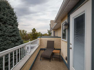 Enjoy your morning coffee or evening relaxation on this private balcony, complete with a comfortable chaise lounge and a convenient side table.