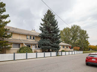 Discover this charming property featuring a stucco exterior and a tiled roof, offering a warm and inviting facade.