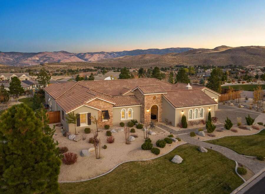 Experience luxury living in this stunning Mediterranean-style estate, nestled against a backdrop of majestic mountains.