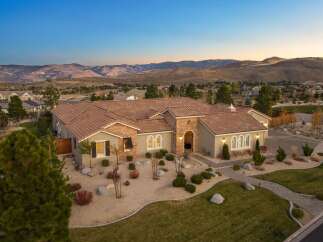 Experience luxury living in this stunning Mediterranean-style estate, nestled against a backdrop of majestic mountains.