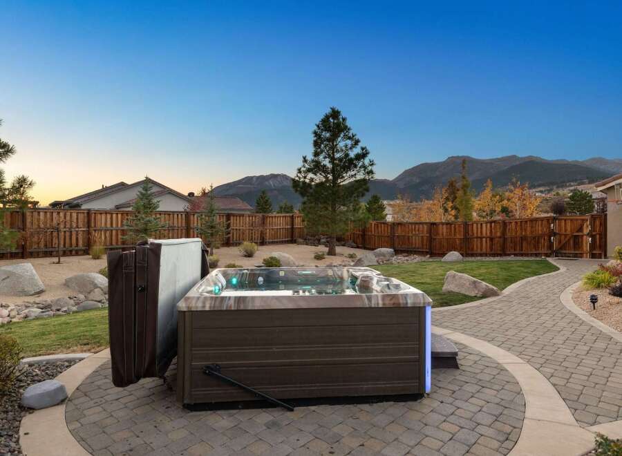 Experience ultimate relaxation in this backyard oasis, featuring a luxurious hot tub perfect for unwinding under the stars.