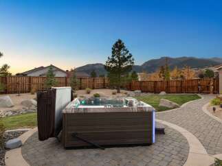 Experience ultimate relaxation in this backyard oasis, featuring a luxurious hot tub perfect for unwinding under the stars.