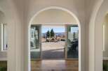 Step through elegant arched doorways into a home that seamlessly blends indoor and outdoor living.
