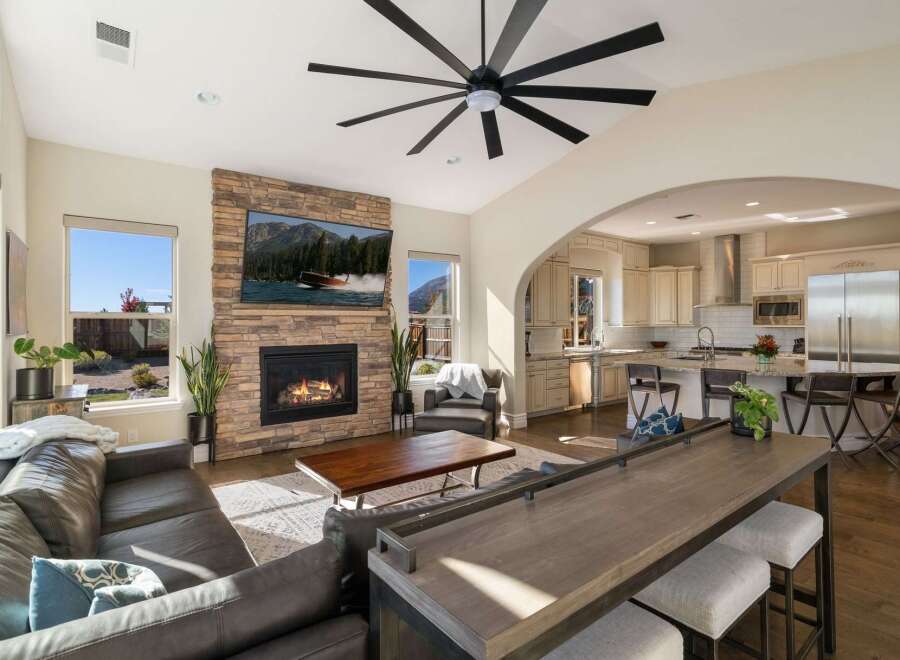Experience modern living in this open-concept home featuring a stunning stone fireplace and a spacious kitchen perfect for entertaining.