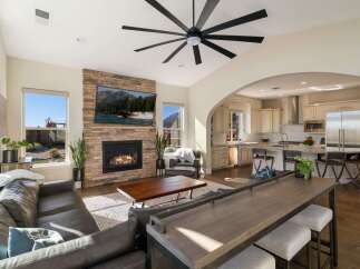 Experience modern living in this open-concept home featuring a stunning stone fireplace and a spacious kitchen perfect for entertaining.