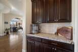 This spacious home features a modern kitchen area with dark wood cabinetry and granite countertops, perfect for entertaining.