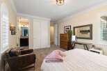 This inviting bedroom features a plush pink throw blanket draped over a white comforter, creating a cozy atmosphere.