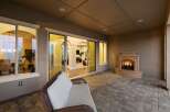 Experience luxurious outdoor living with this stunning patio featuring a cozy fireplace and comfortable seating.