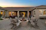 Experience luxurious outdoor living with this stunning patio featuring a central fire pit, perfect for cozy evenings.