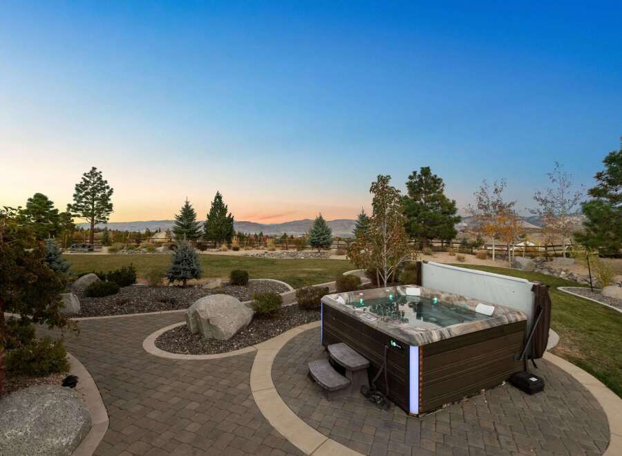 Experience luxurious outdoor living with this stunning backyard oasis, featuring a modern hot tub perfect for relaxation.