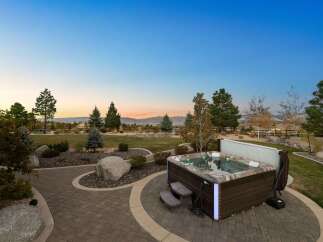 Experience luxurious outdoor living with this stunning backyard oasis, featuring a modern hot tub perfect for relaxation.