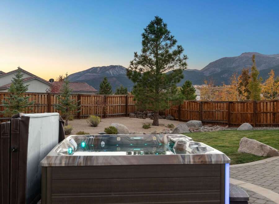 Experience ultimate relaxation in this backyard oasis, complete with a luxurious hot tub featuring vibrant LED lighting.