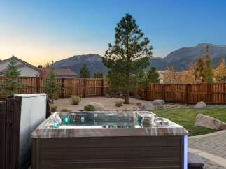 Experience ultimate relaxation in this backyard oasis, complete with a luxurious hot tub featuring vibrant LED lighting.