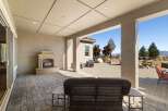 Enjoy outdoor living with this spacious covered patio, featuring a cozy fireplace perfect for cooler evenings.