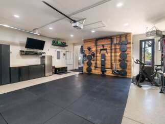 Transform your garage into a high-performance home gym with this fully equipped space.